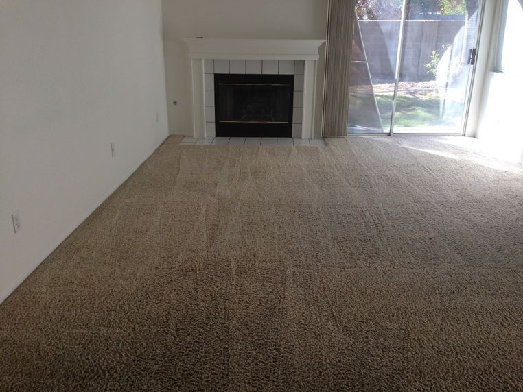A living room with a fireplace and a sliding glass door.
