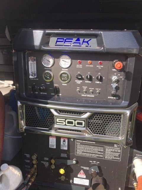 A black and silver machine with the word peak on it