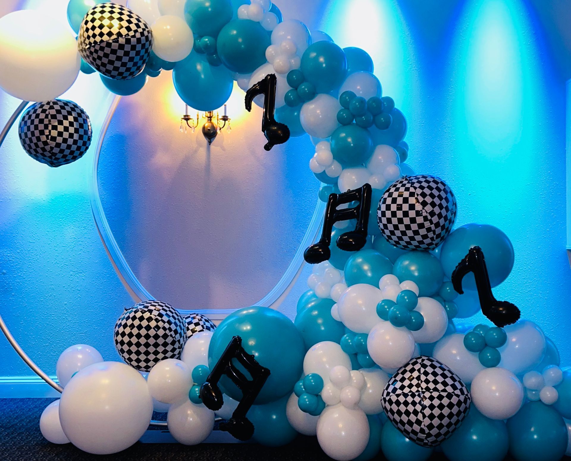 A bunch of blue and white balloons with music notes on them