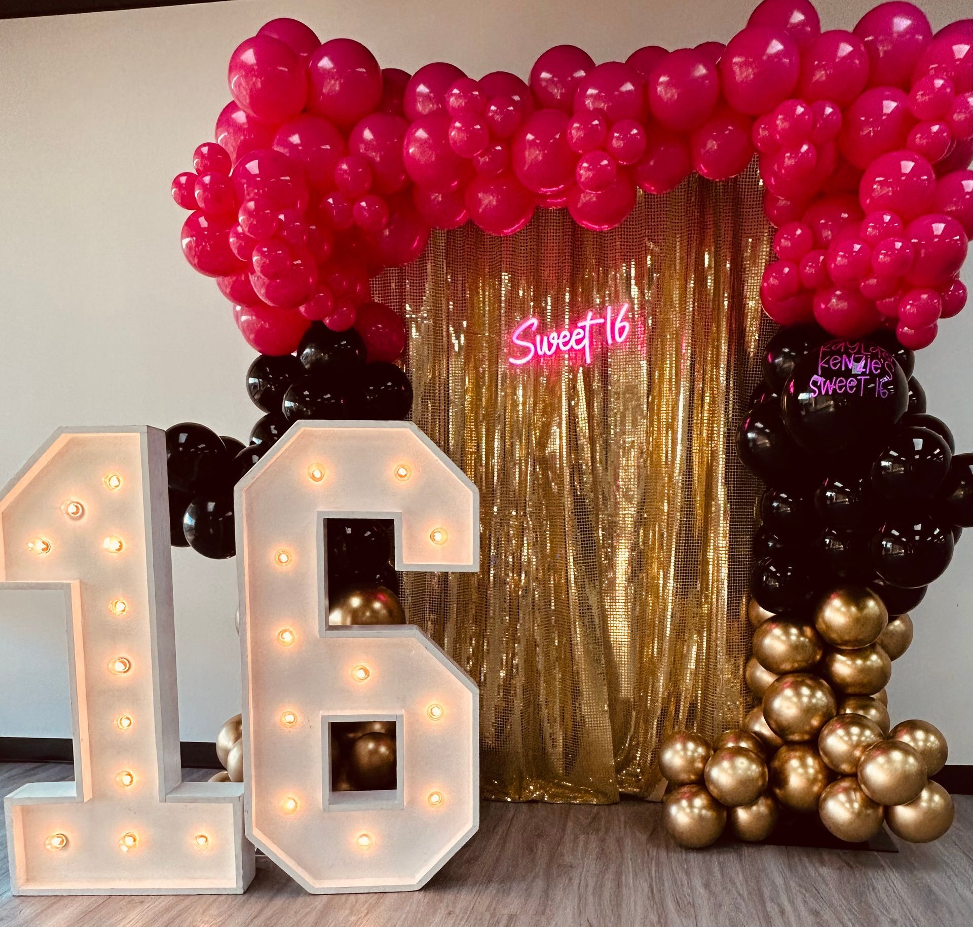 A bunch of colorful balloons are stacked on top of each other in a living room.