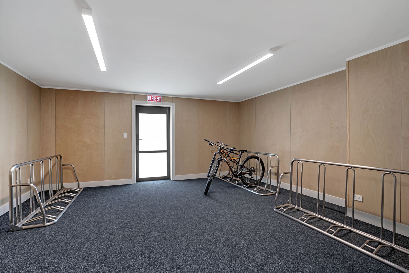 A white and yellow bicycle is parked on the sidewalk