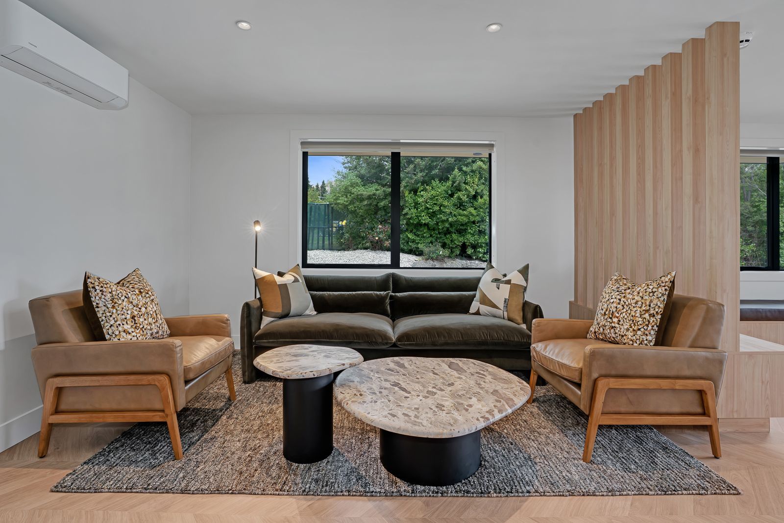 A man is carrying a snowboard up a snowy hill.