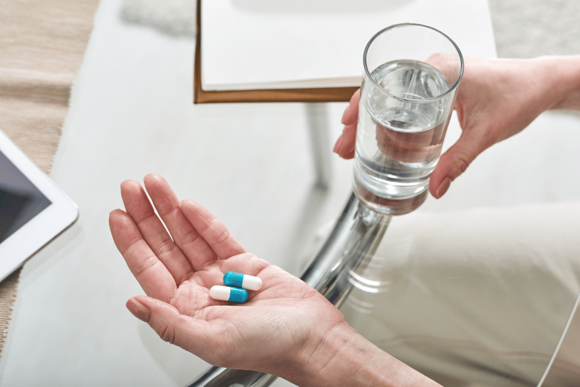 Senior in Nebraska holding daily prescription pills and a glass of water as part of Medicare Part D drug coverage