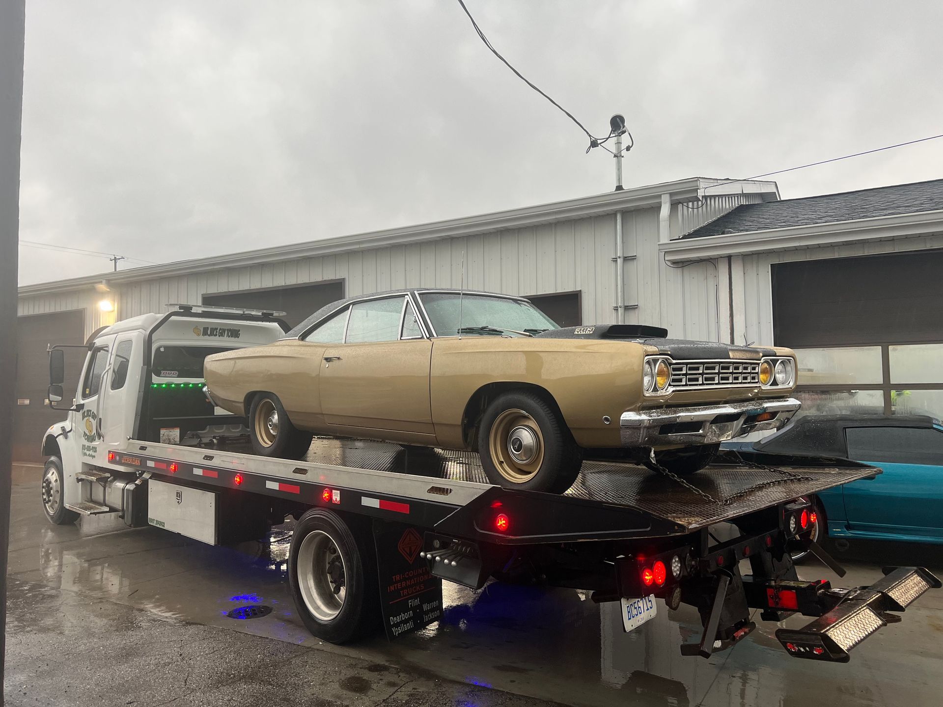 A car is being towed by a tow truck.