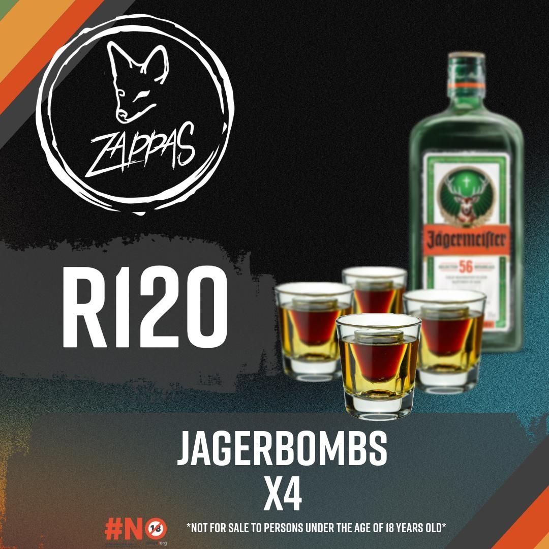 A bottle of jagerbombs next to four shot glasses
