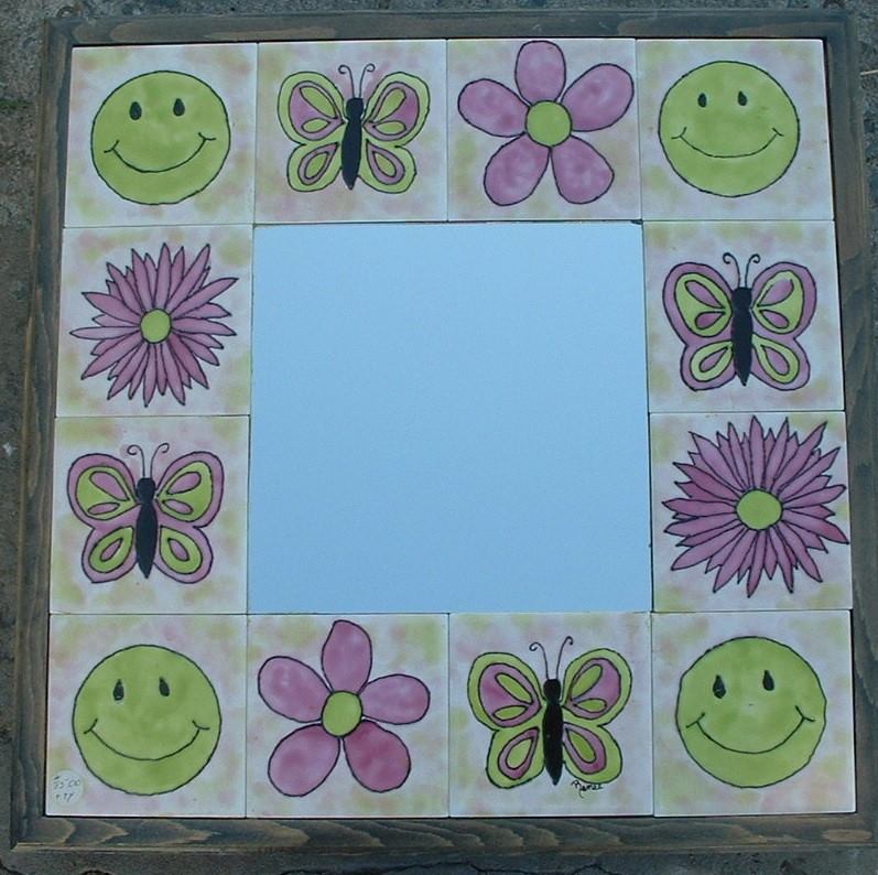 A mirror with smiley faces and butterflies on it