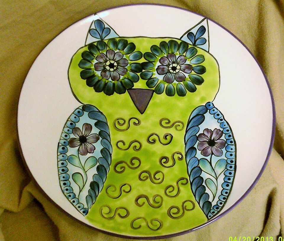 A white plate with a green owl on it