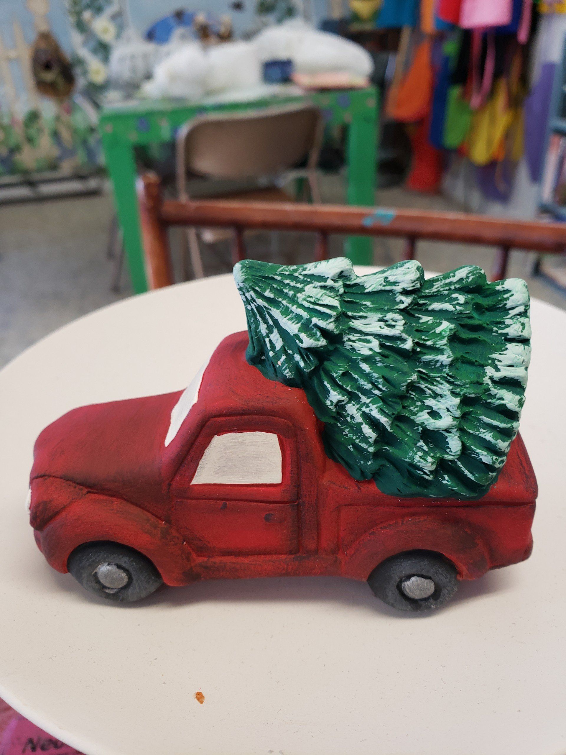 A red truck with a christmas tree on top of it.