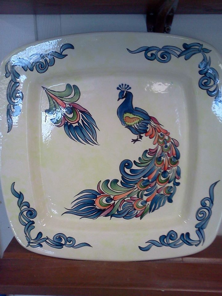 A square plate with a peacock on it