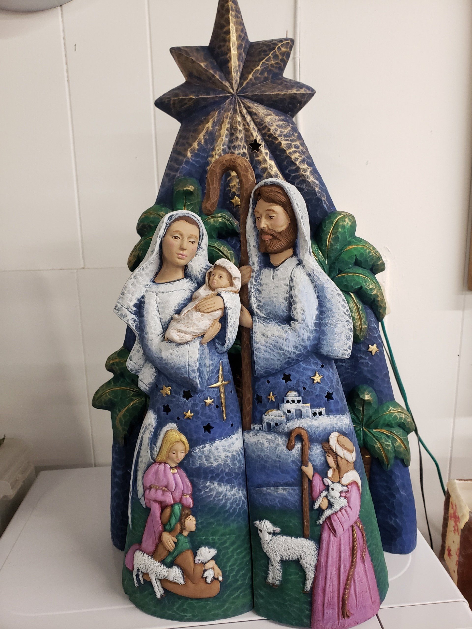 A nativity scene with a star on top of it