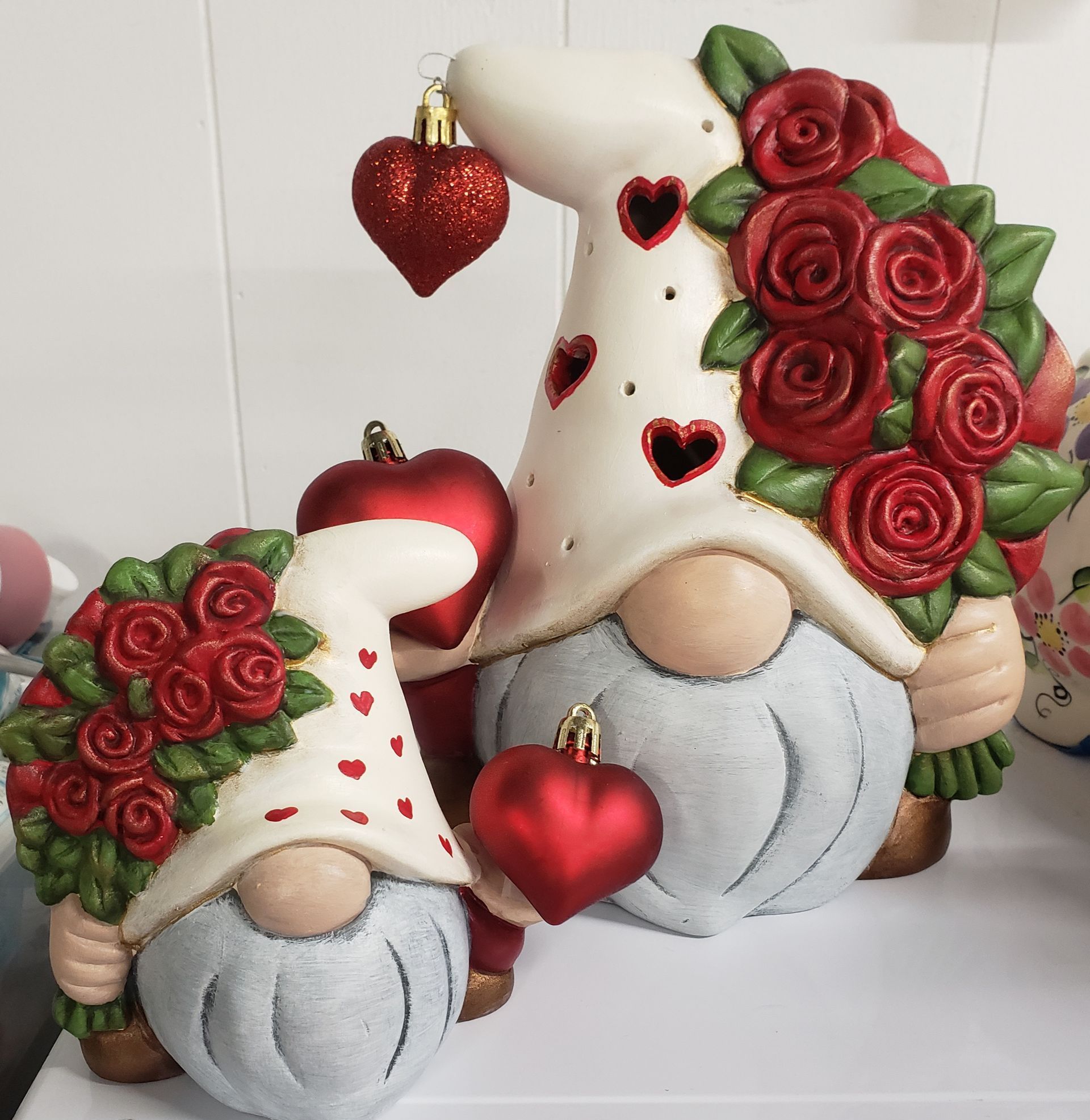 A couple of gnomes with hearts and roses on them