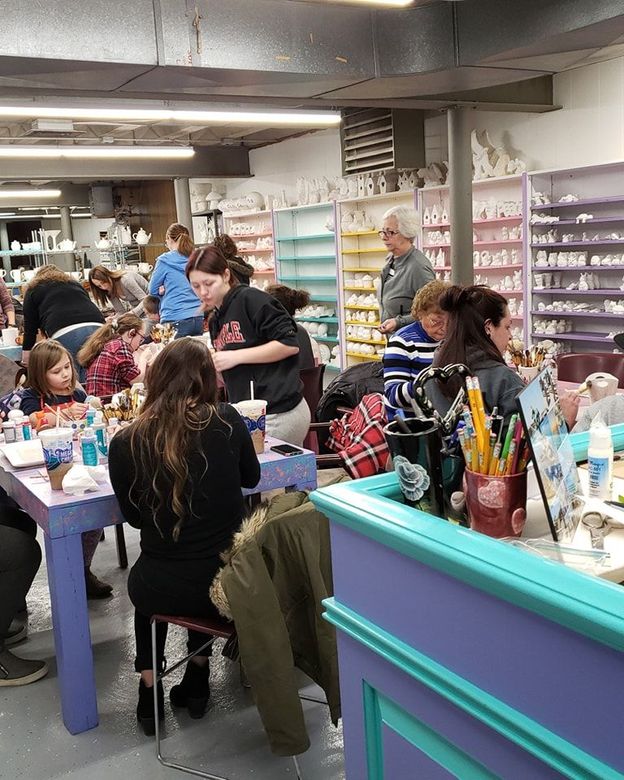 Three teddy bears sitting on top of a sign that says happy day