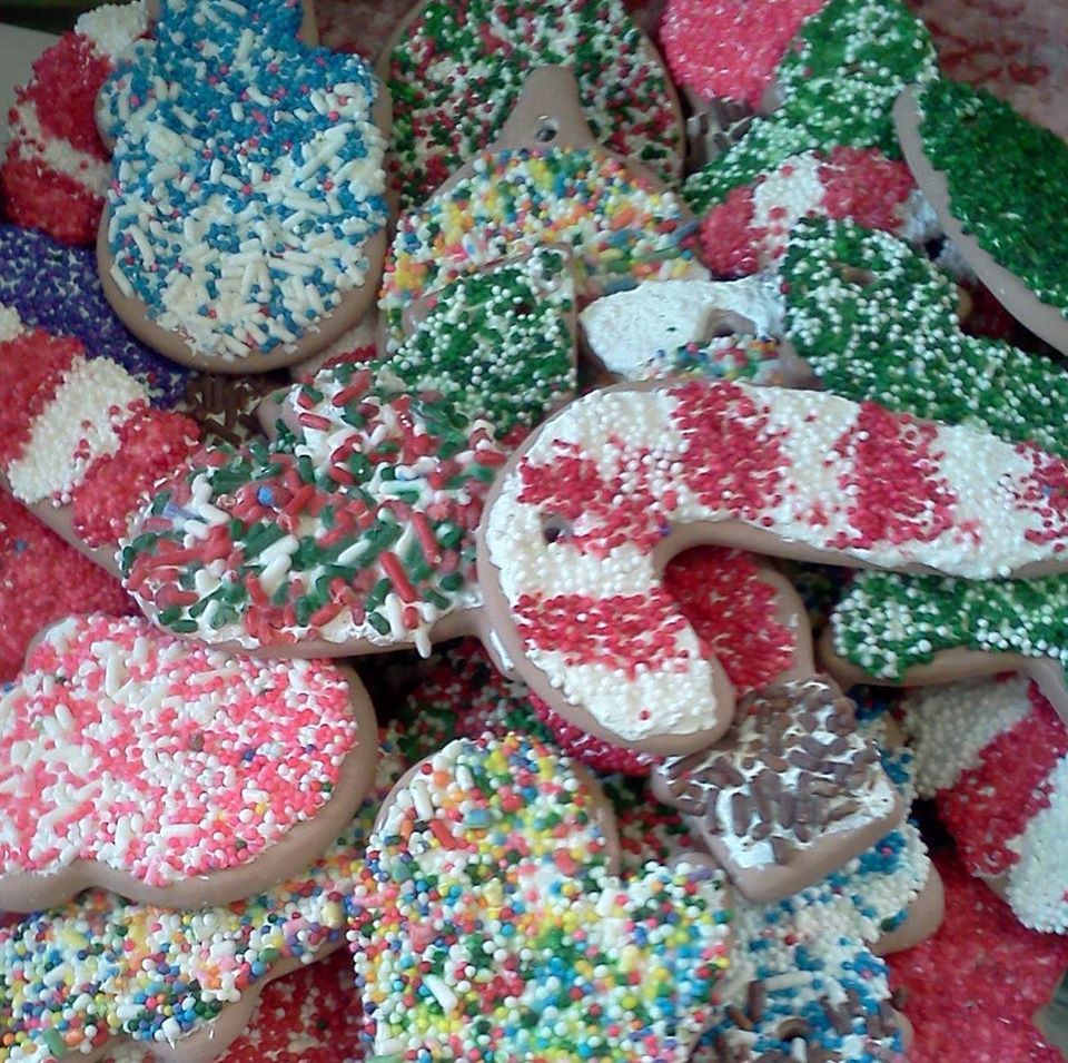 A pile of christmas cookies with sprinkles on them