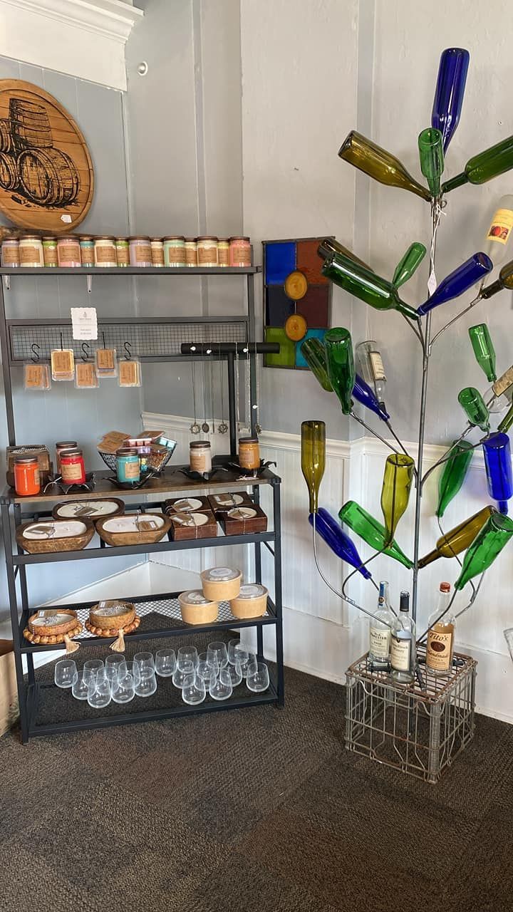 A room with a tree made out of wine bottles and candles.