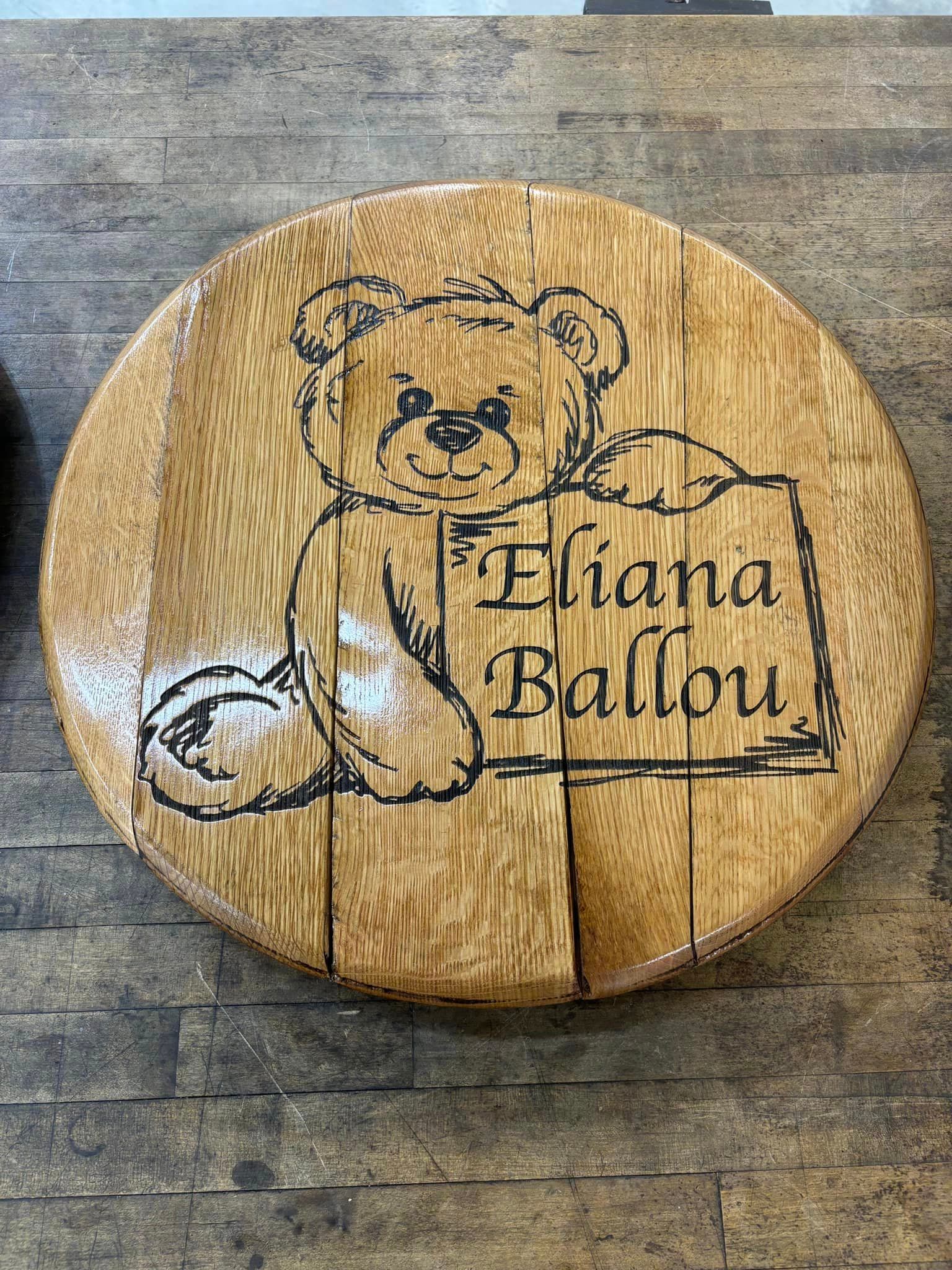 A wooden cutting board with a teddy bear on it.