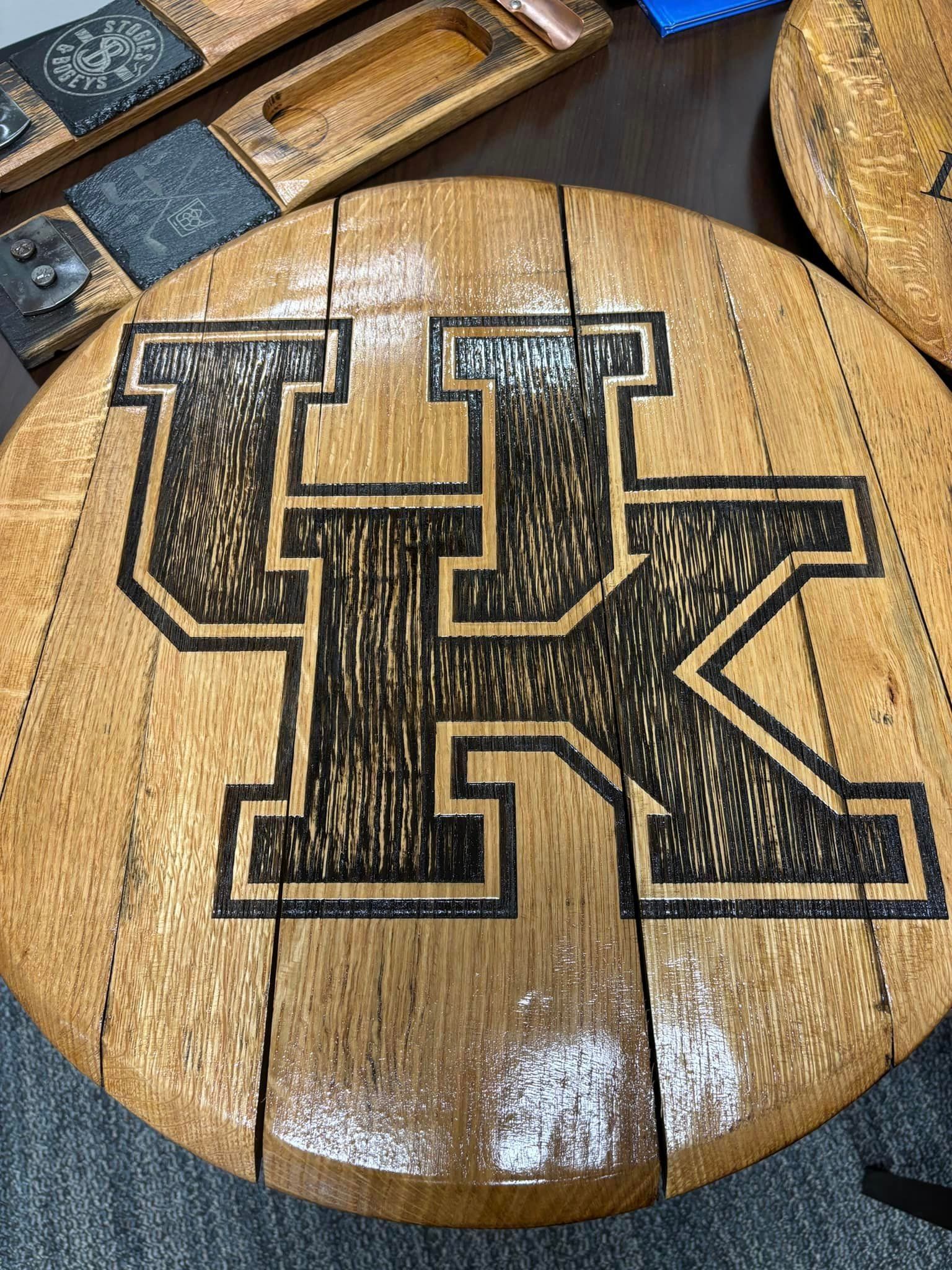 A wooden table with the letter k carved into it.