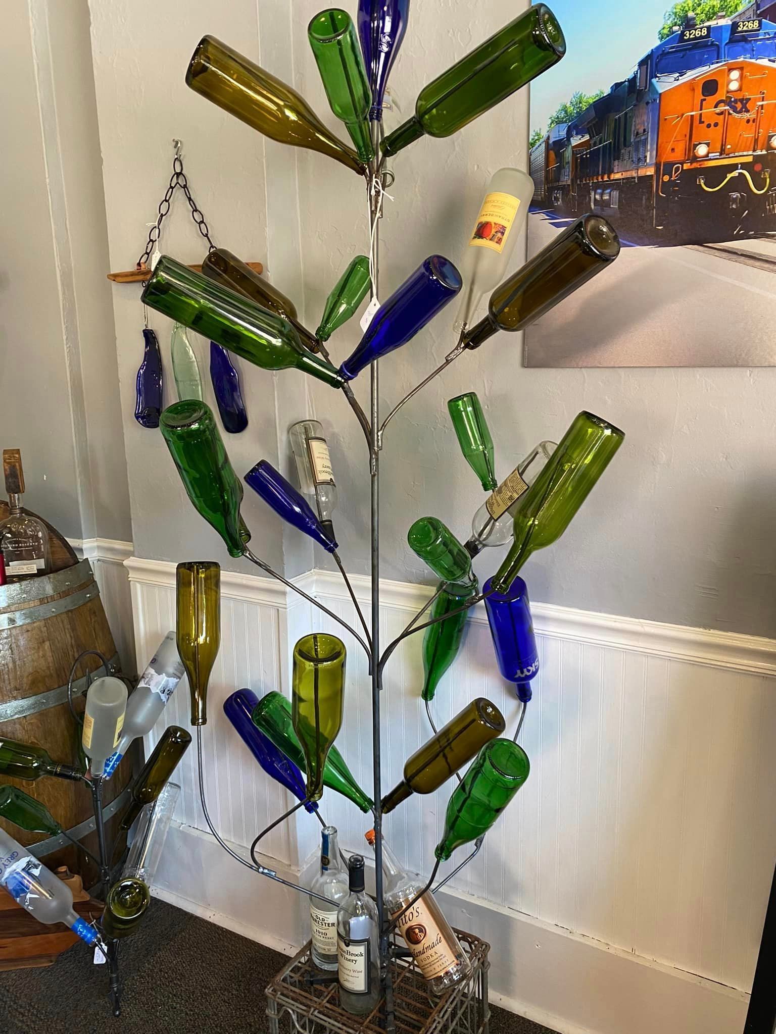 A christmas tree made out of wine bottles in a room.