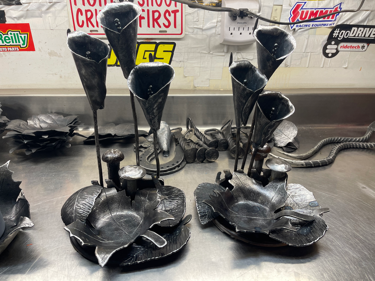 A couple of metal sculptures are sitting on a table.