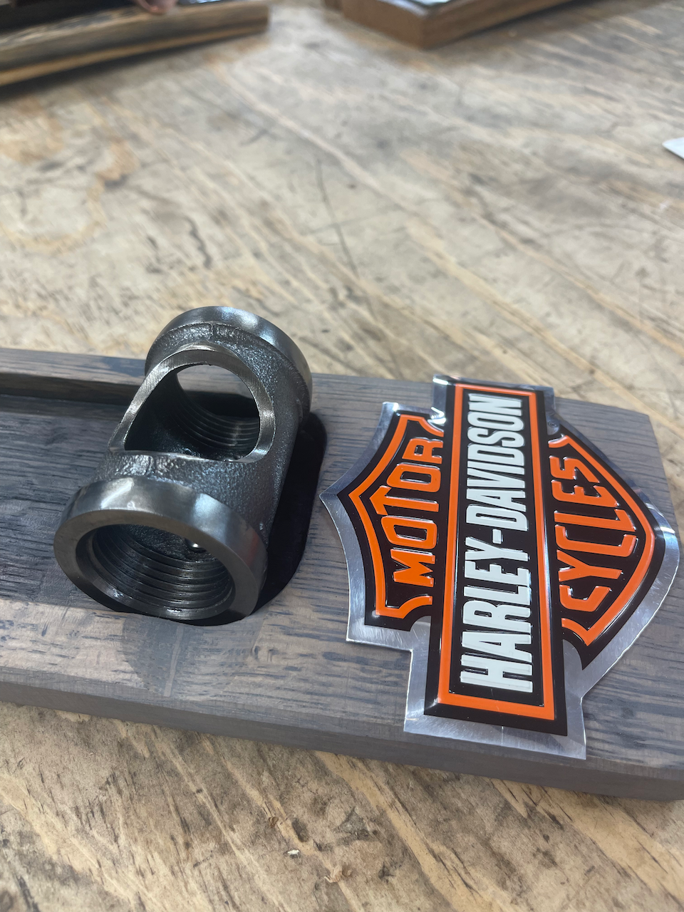 A harley davidson logo is on a piece of wood
