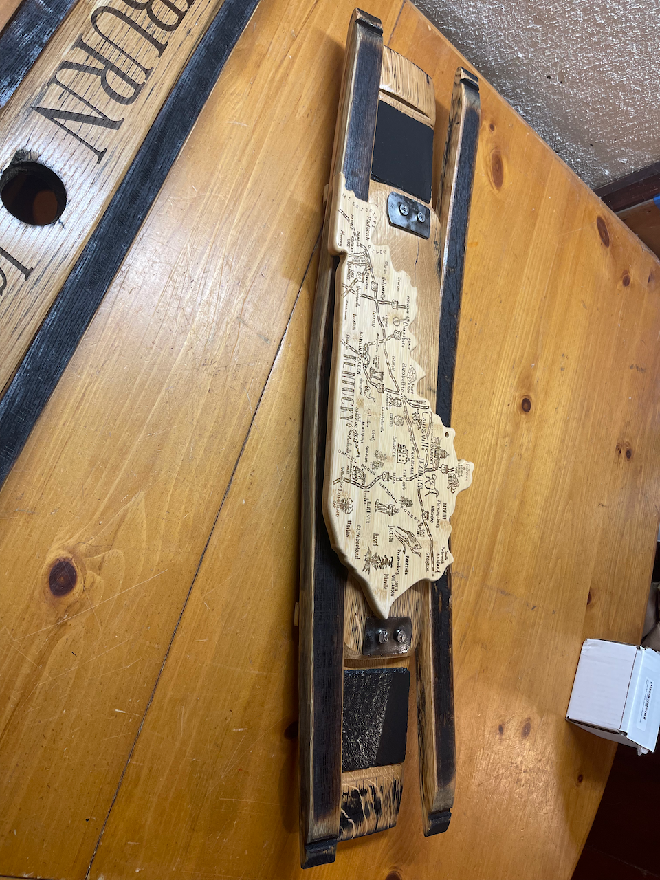 A piece of wood is sitting on top of a wooden table.