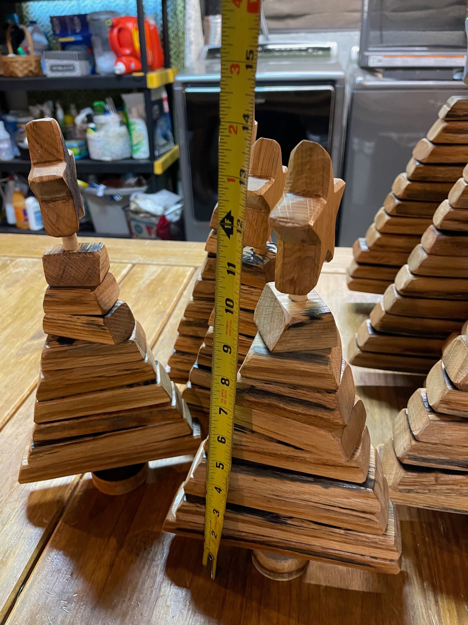 Three wooden pyramids are stacked on top of each other on a wooden table.