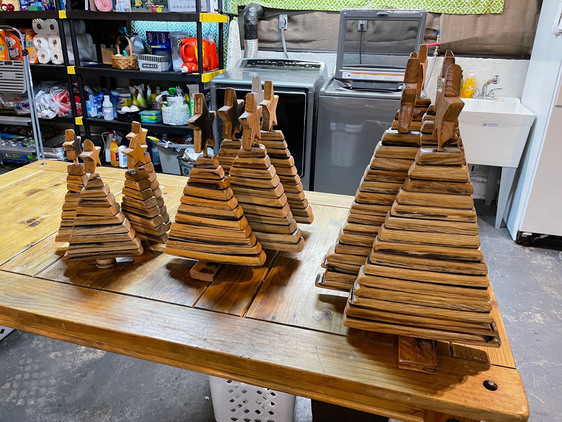 A group of wooden christmas trees are sitting on top of a wooden table.
