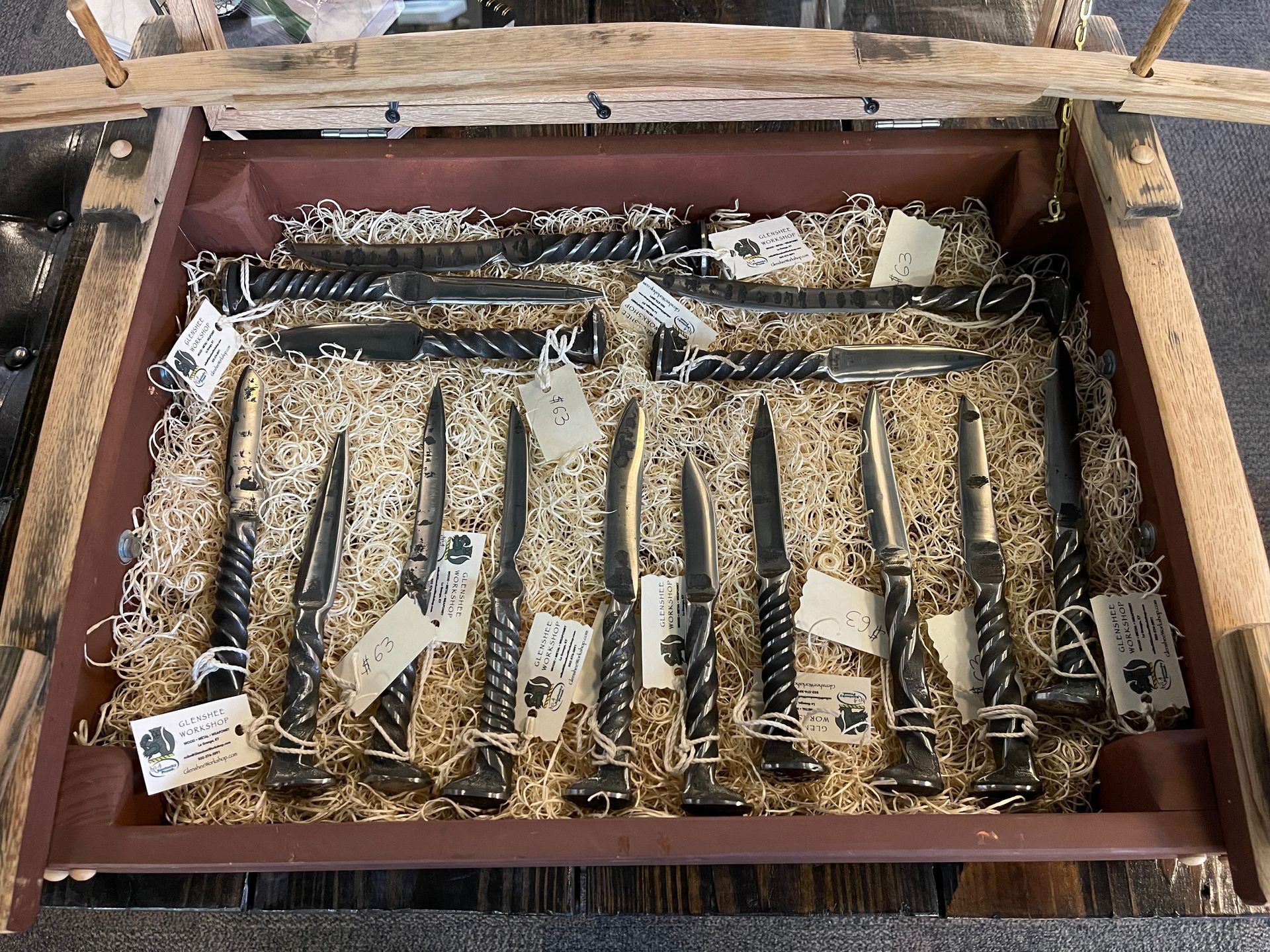 A wooden box filled with knives and forks