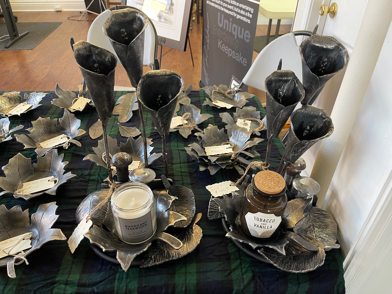 A table with a lot of candles and plates on it