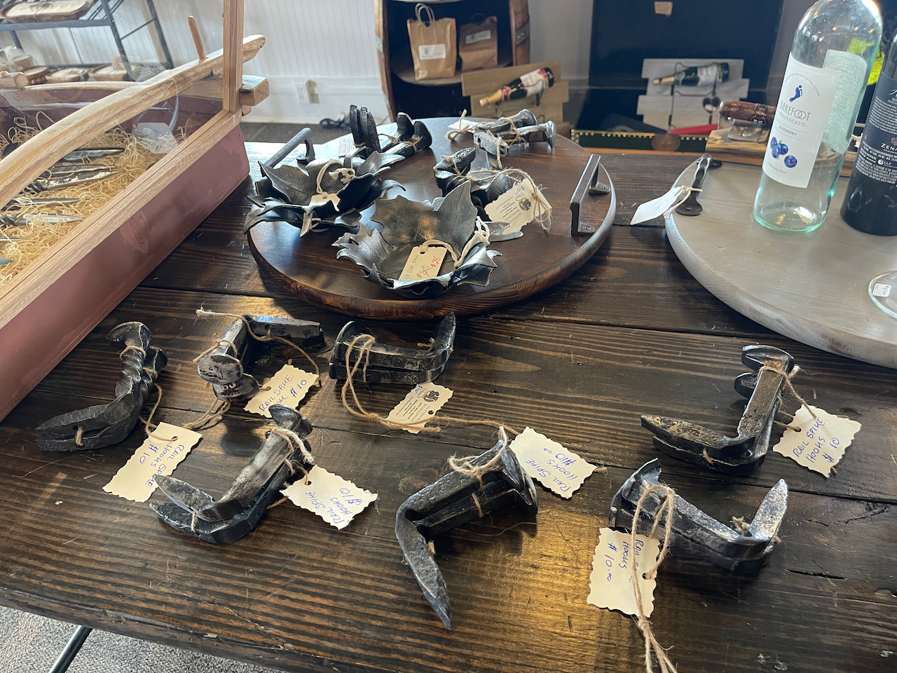 A table with a bunch of objects on it and a bottle of water.