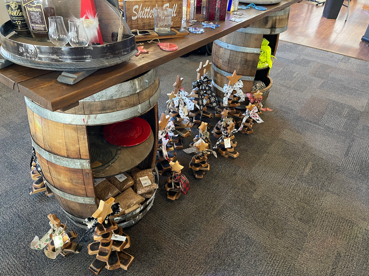 A table made out of wooden barrels with candles on it.