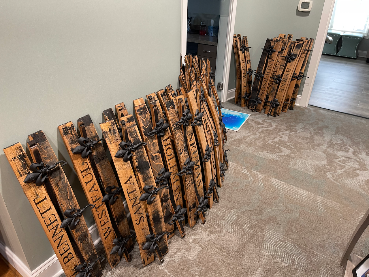 A bunch of wooden signs are stacked on top of each other in a room.