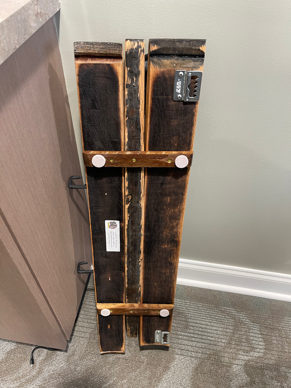 A piece of wood is sitting on the floor next to a wall