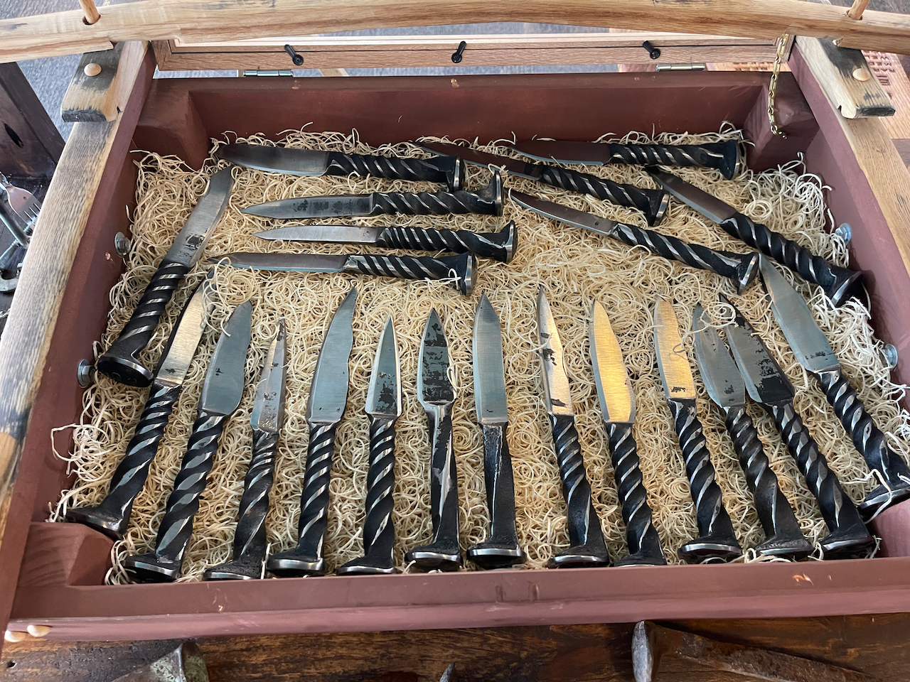 A drawer filled with knives and forks made out of nails