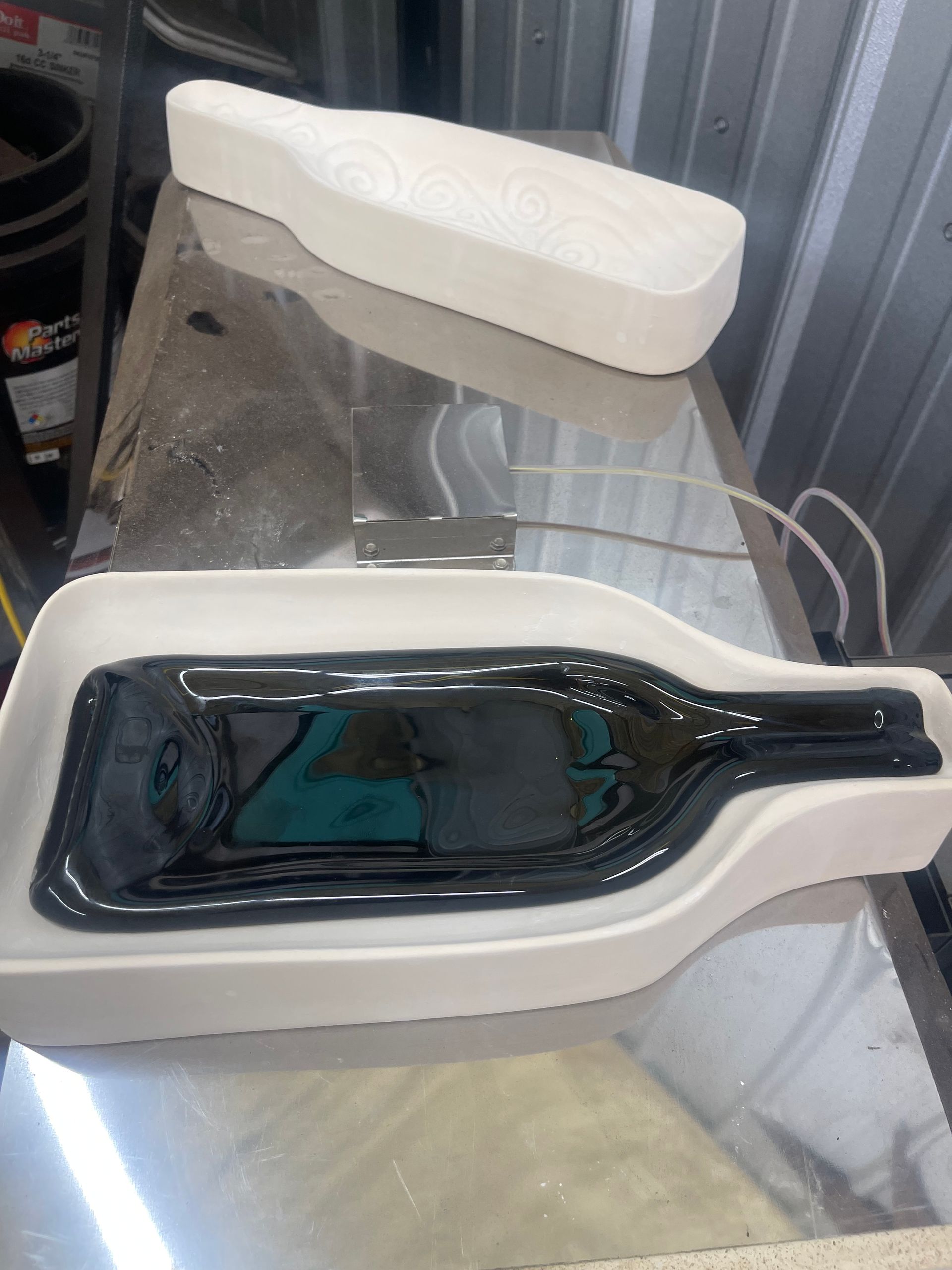 A bottle of wine is sitting on top of a white tray.