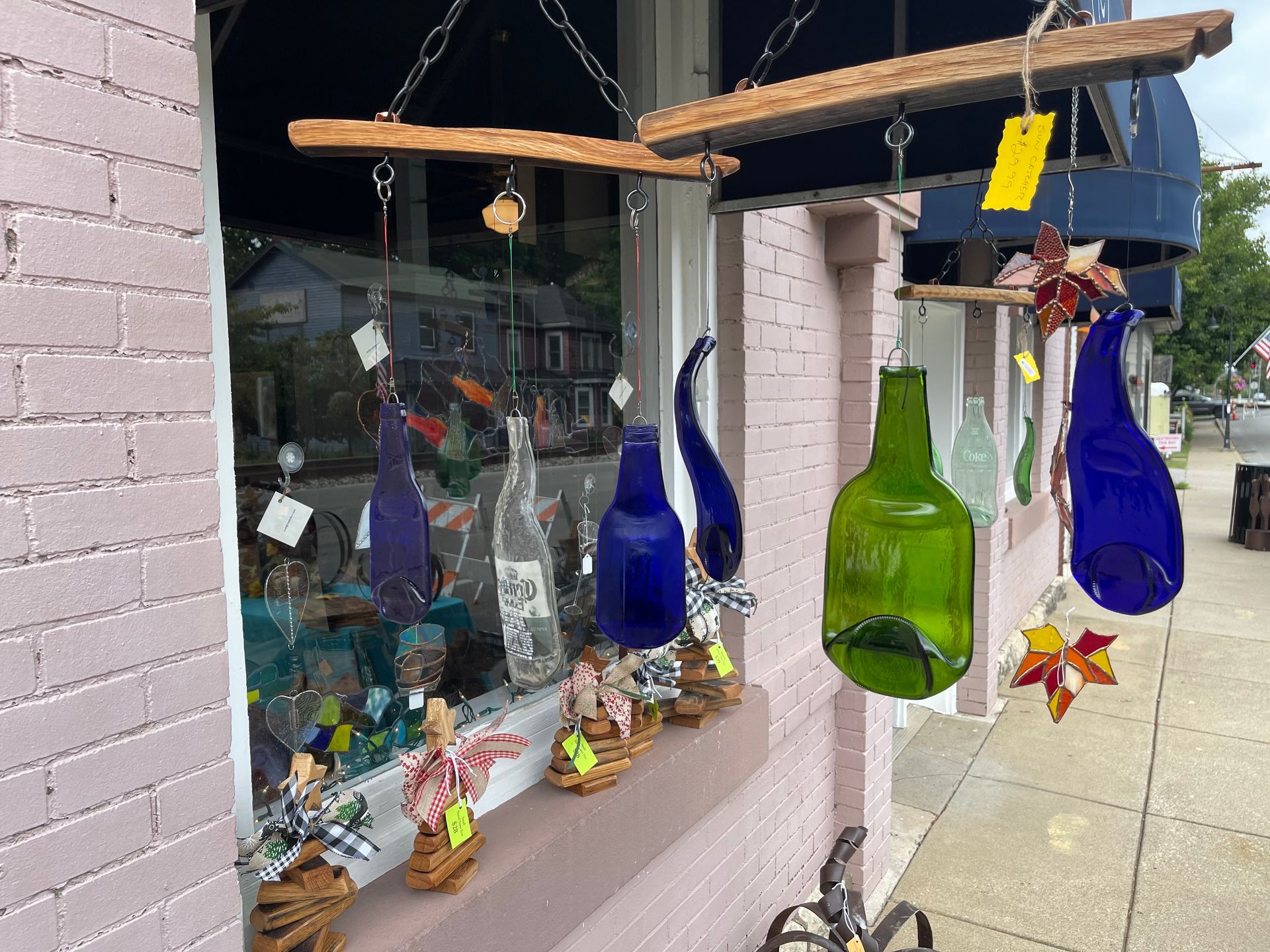 A window with a bunch of bottles hanging from it