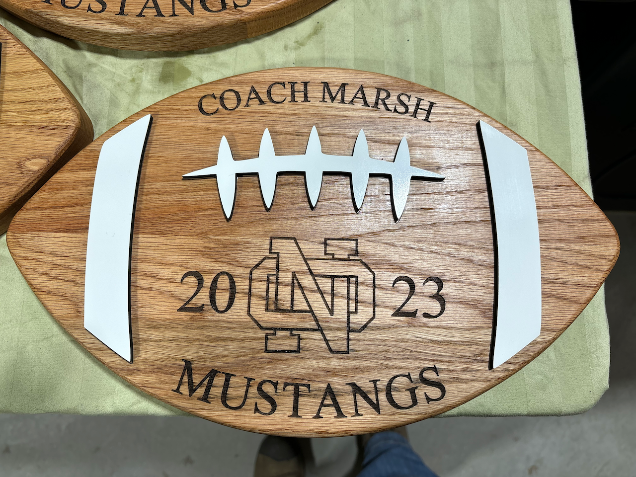 A wooden sign with the name griffin on it is hanging on a wall.