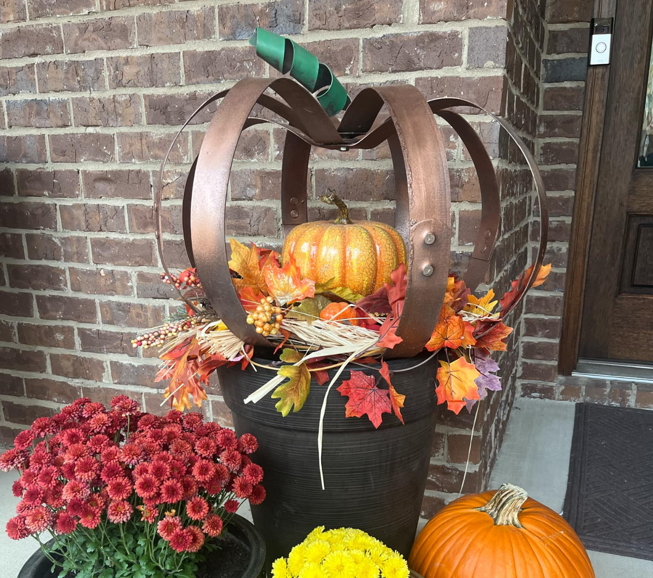 A large metal sculpture is sitting on a carpeted floor.