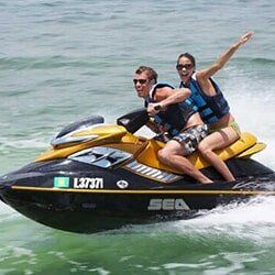 Jetski Rental — Couple Riding on a Jetski in Orange Beach, AL