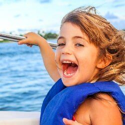 Happy Girl Riding a Boat — Boat Club in Orange Beach, AL