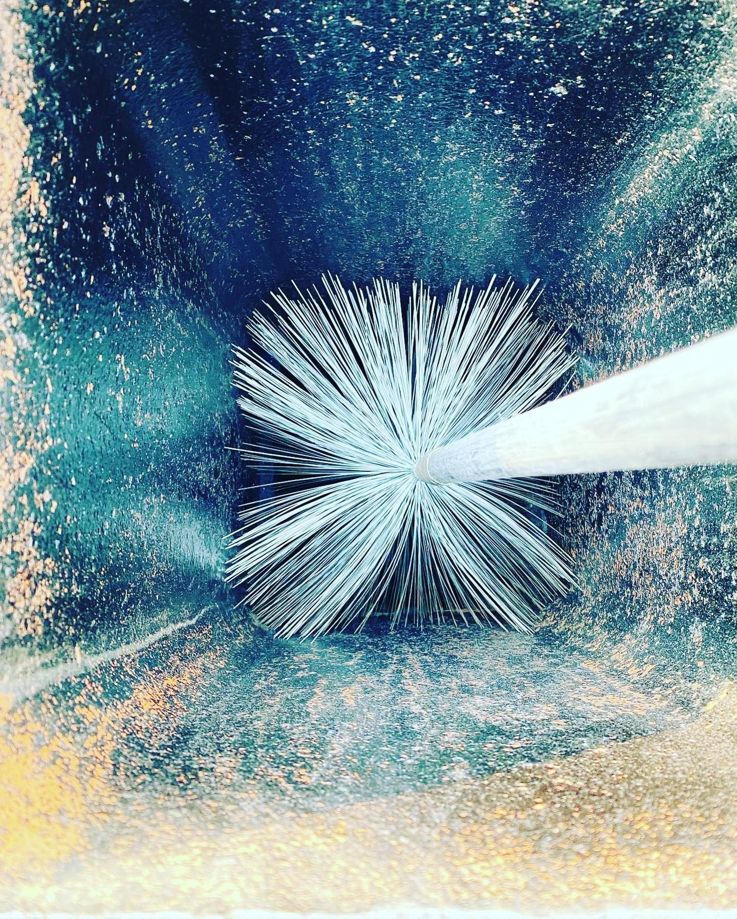 Abstract artwork:  Radiating white lines emerge from a dark square against a backdrop of blue and teal hues.