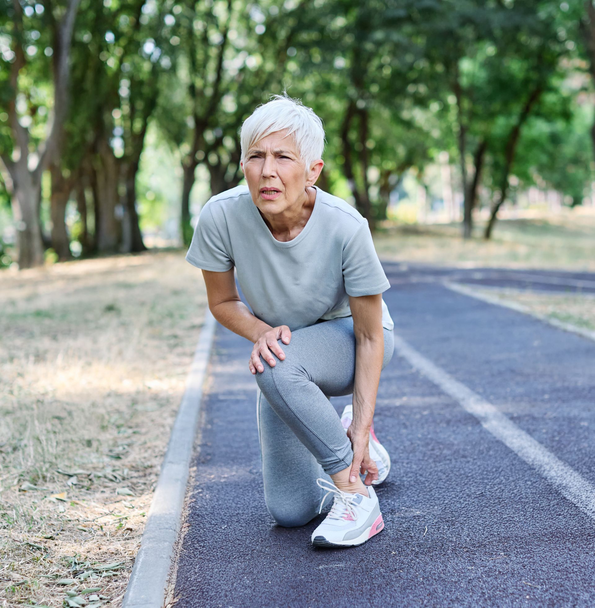 A woman in white underwear is standing in front of a white wall.