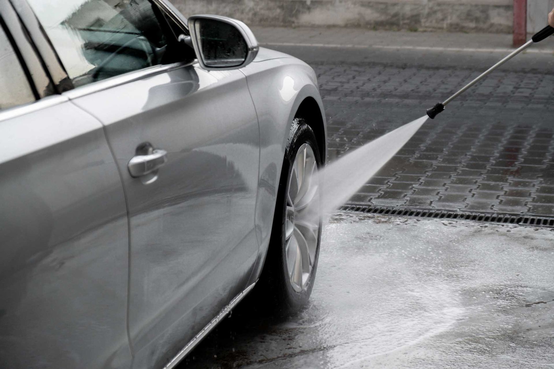 Washing luxury silver car on touchless car wash. Washing luxury silver car on touchless car wash.