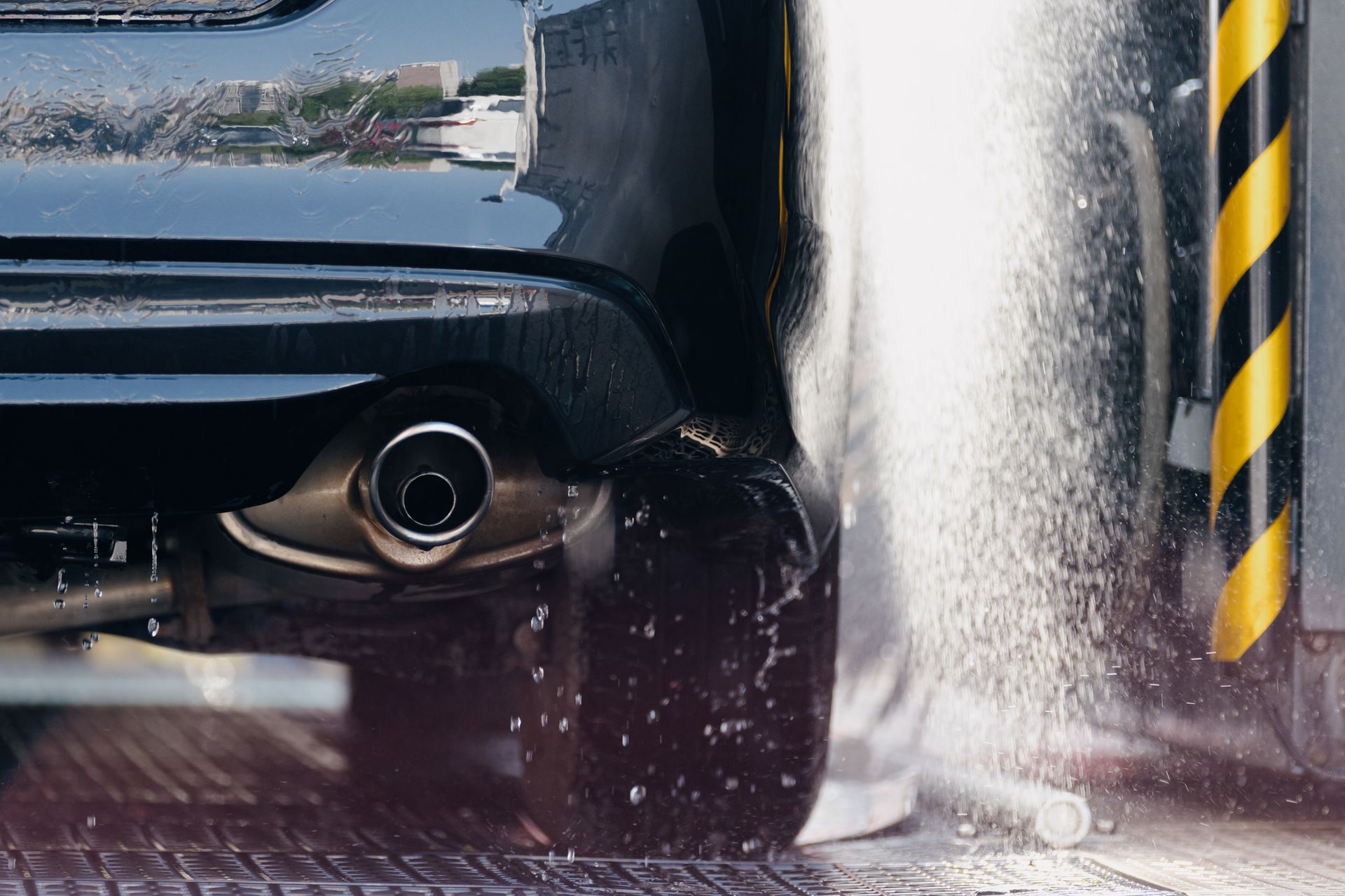 Automatic car wash in action removing dirt and grime from a vehicle.