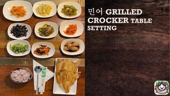 A grilled crockpot table setting with plates of food on it