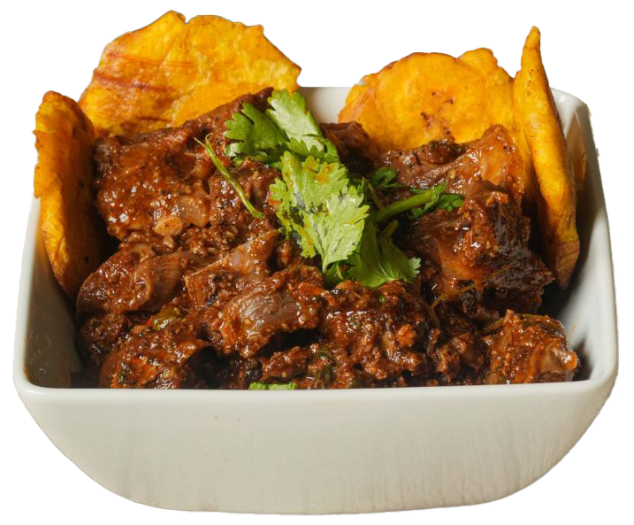Stewed meat dish with plantain chips in a white bowl, garnished with cilantro.