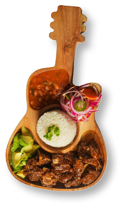 A wooden guitar-shaped serving platter holds rice, beans, avocado, meat, and a dish with red onion and jalapeño.