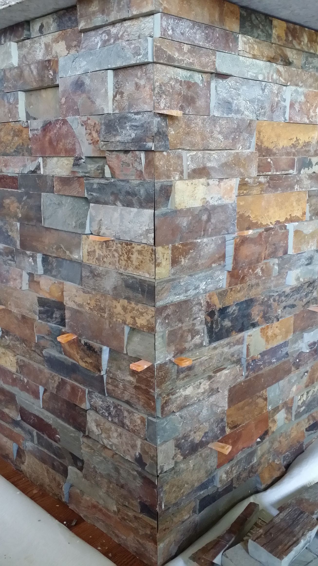 Stone veneer corner in shades of brown, gray, and tan.