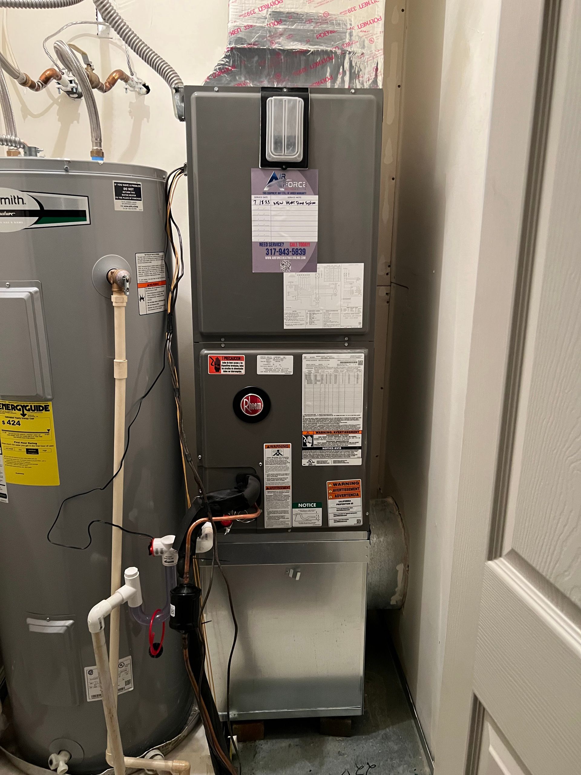 Water heater and HVAC unit in a utility room; pipes and ductwork visible.