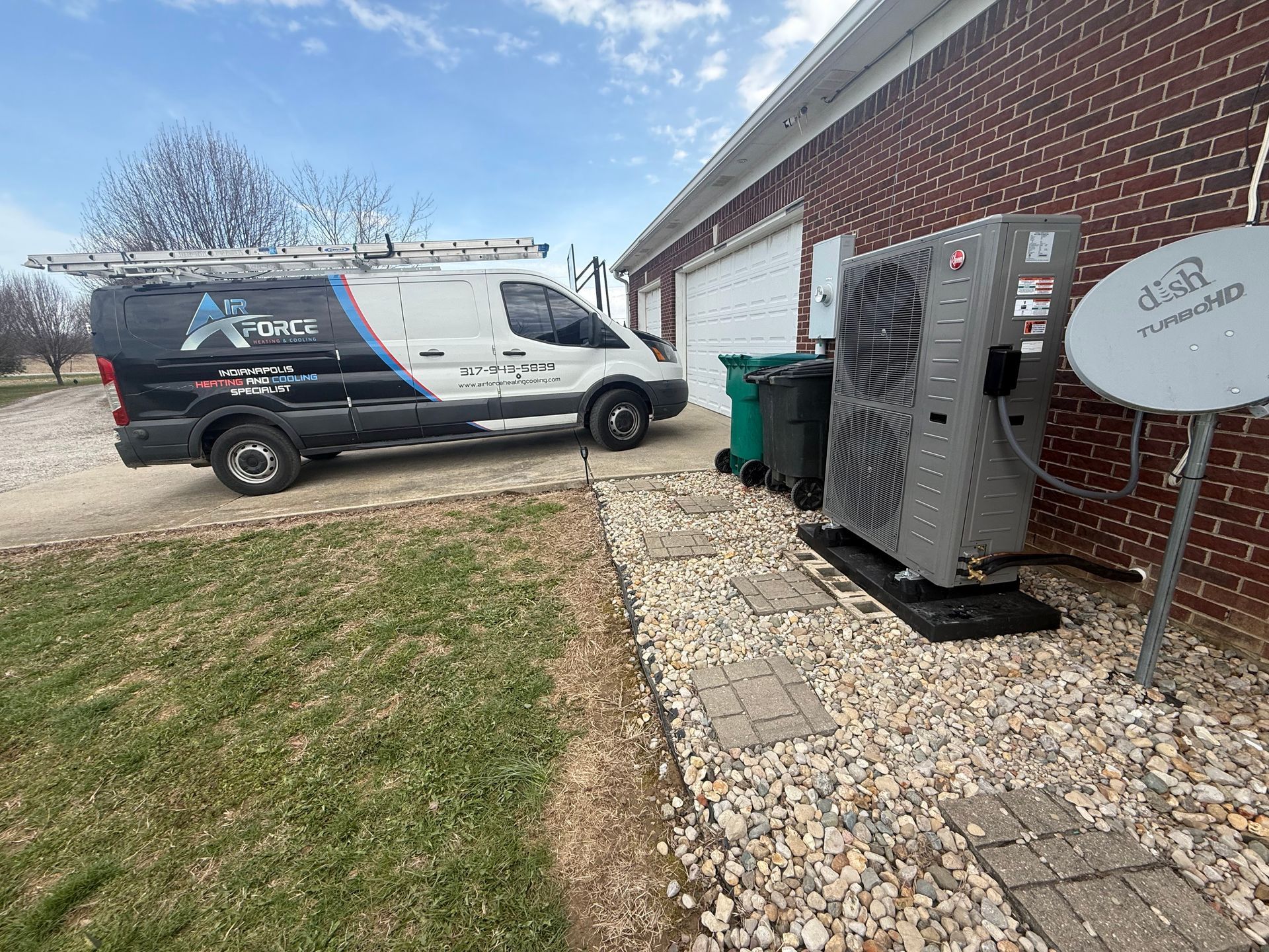 Service van parked near a house with an outdoor HVAC unit and satellite dish on a sunny day.
