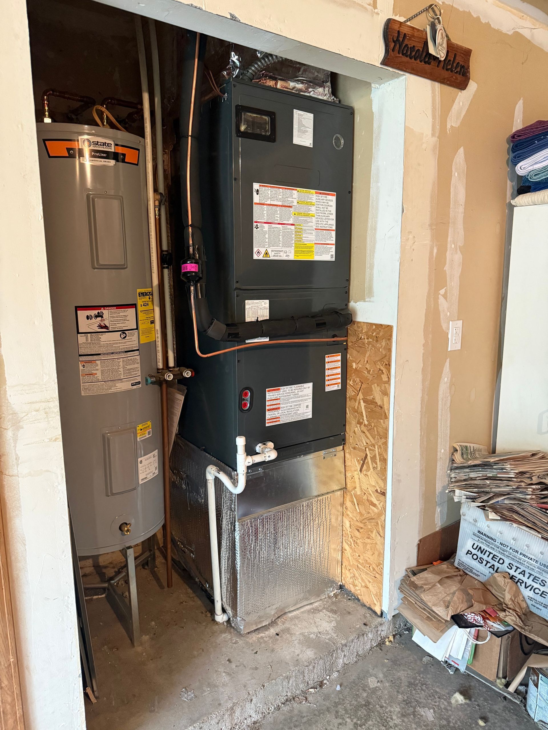 Water heater and furnace in an alcove with exposed wood and sheet metal ducting.